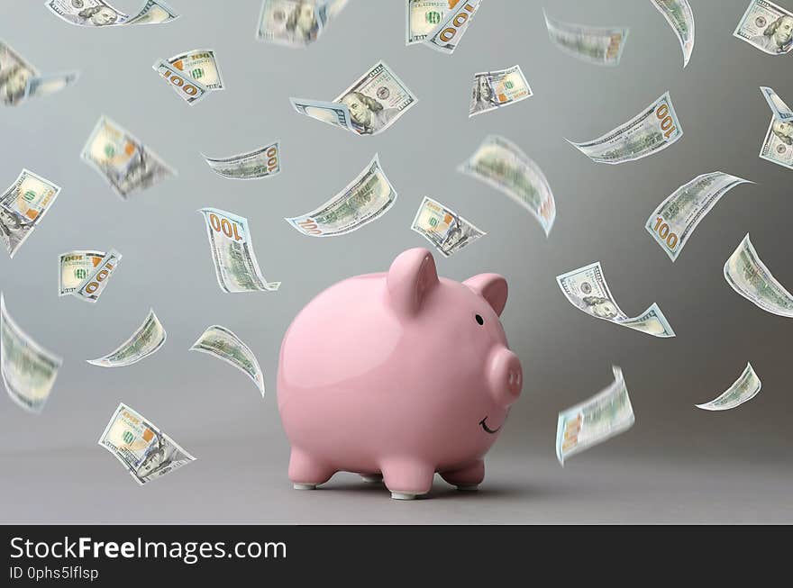 Cute pink piggy bank on gray background