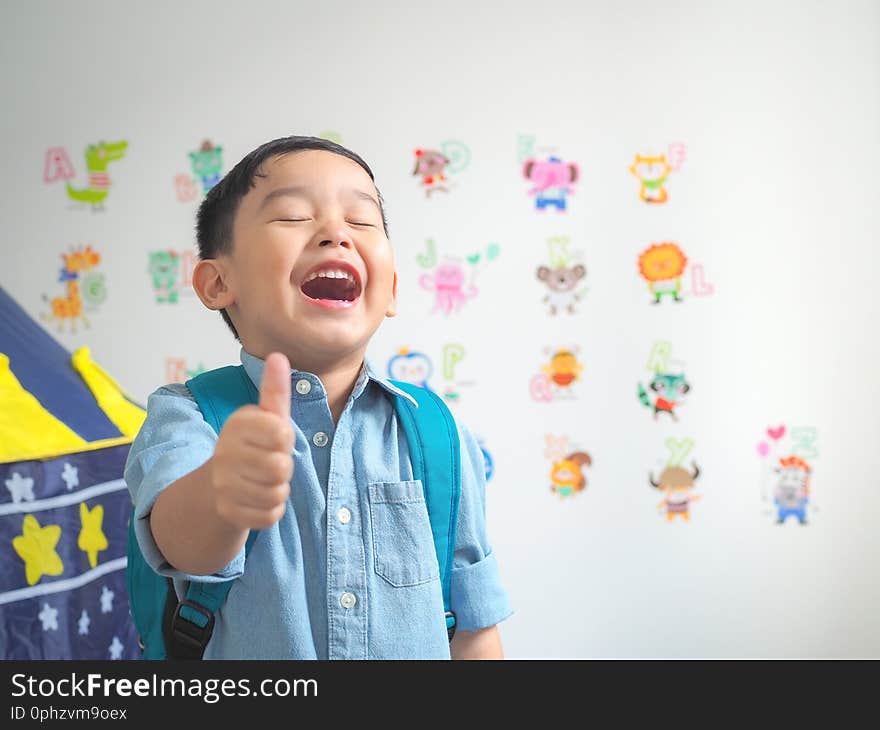 Happy smiling boy with showing thumbs up