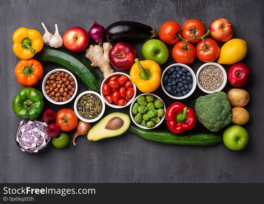 Healthy eating ingredients: fresh vegetables, fruits and superfood. Nutrition, diet, vegan food concept. Concrete background