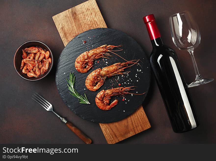 Shrimp with bottle wine on rusty background