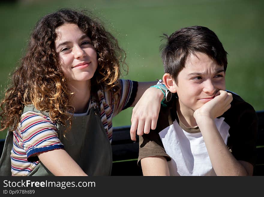 Close-up photograph of a children`s couple formed by brother and sister in a park. Close-up photograph of a children`s couple formed by brother and sister in a park