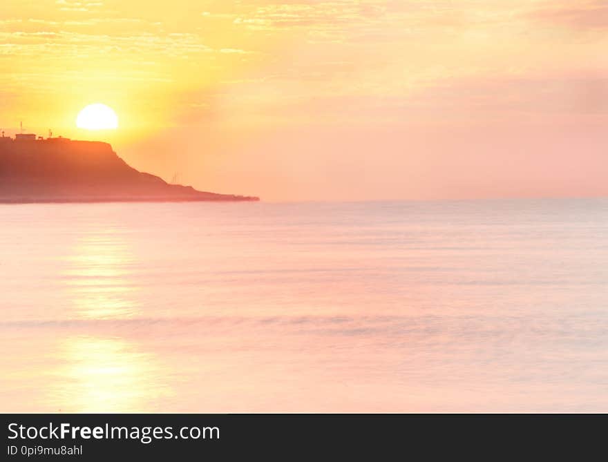 Dawn Of The Sea Bliss. Pink Water And The Sky, The Sun Rising From The Rocks.