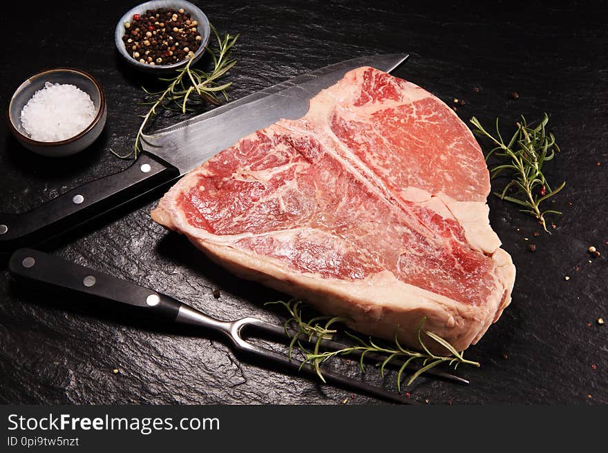 Raw T-bone steak on stone cutting board