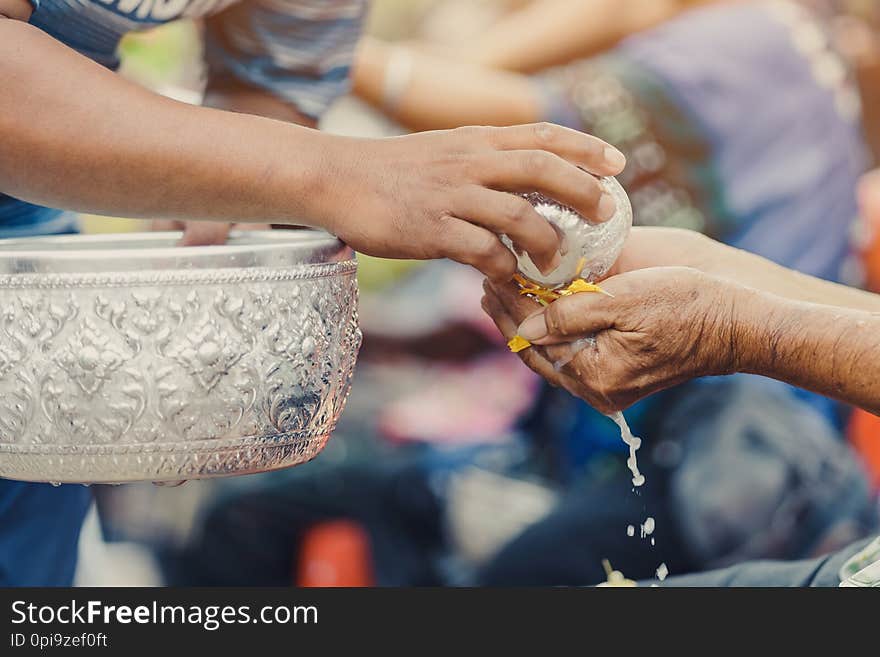 Thai People Celebrate Songkran By Pouring Water And Giving Garlands To Elder Senior Or Respected Grandparents And Elder And Asked