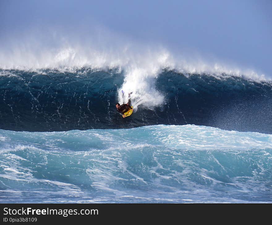 Surfer riding huge Atlantic waves