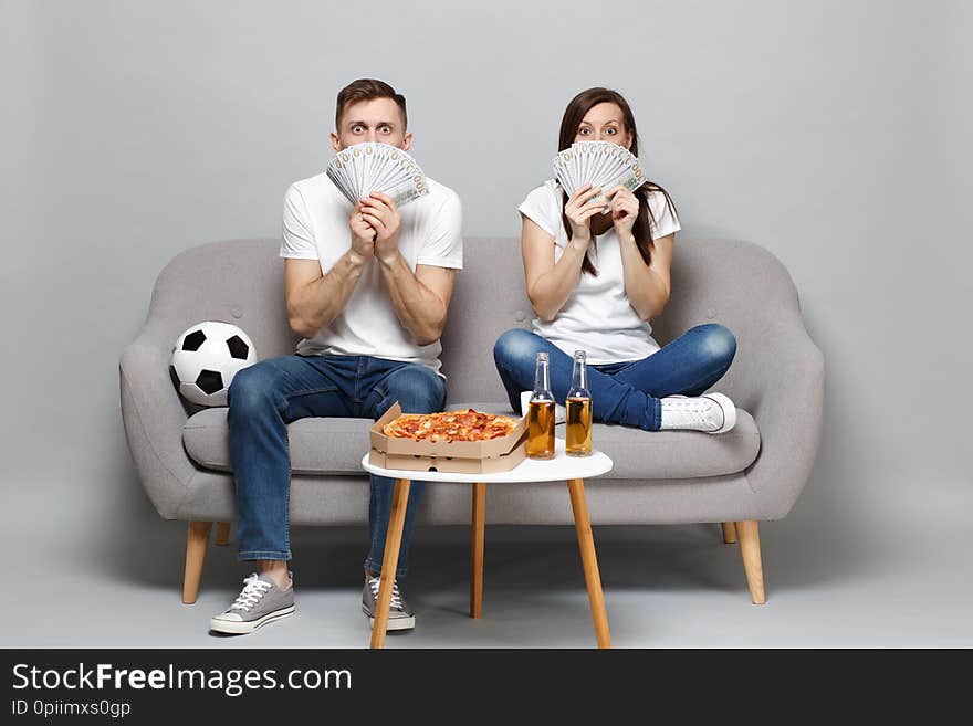 Shocked Couple Woman Man Football Fans Cheer Up Support Favorite Team, Covering Face With Fan Of Money In Dollar