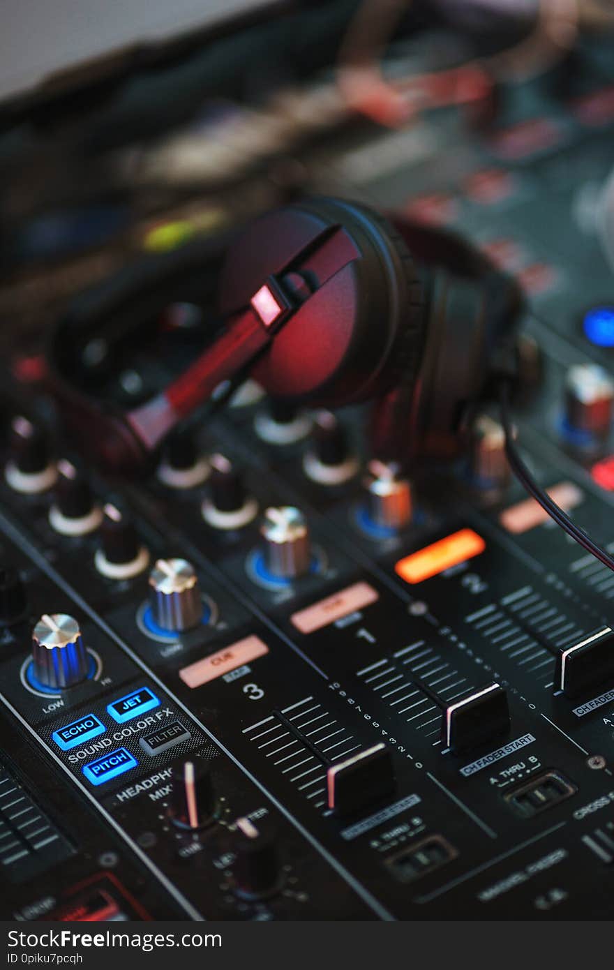 DJ equipment. Player and mixing console with headphones. Night club, music and DJ performance. Nightlife, learning concept. Soft focus and beautiful bokeh.