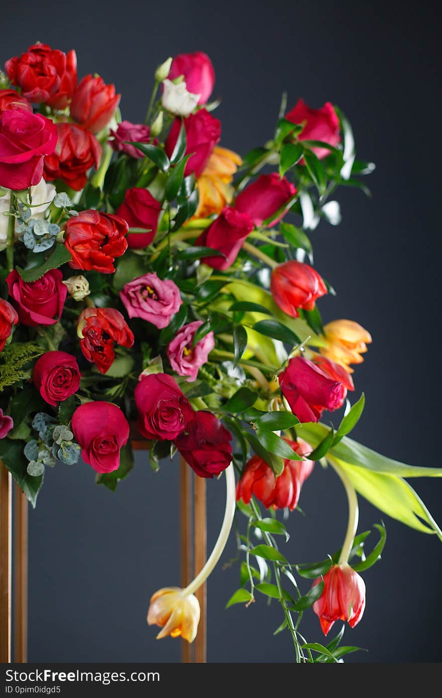 Beautiful flowers on black background. Elegant wedding ceremony. Black room decorated with red flowers