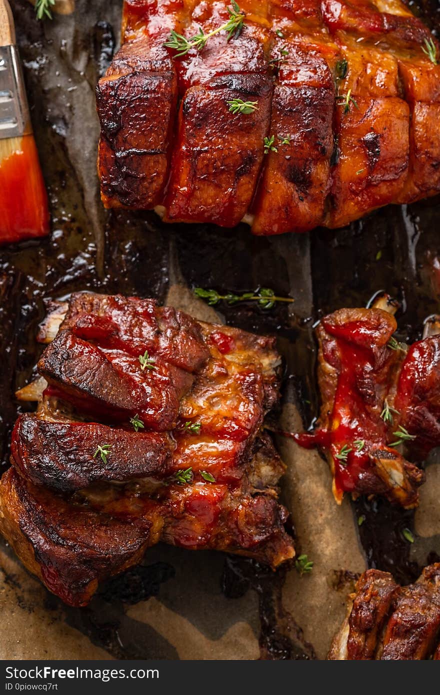 Grilled pork ribs on white baking paper, top view. Grilled pork ribs on white baking paper, top view.