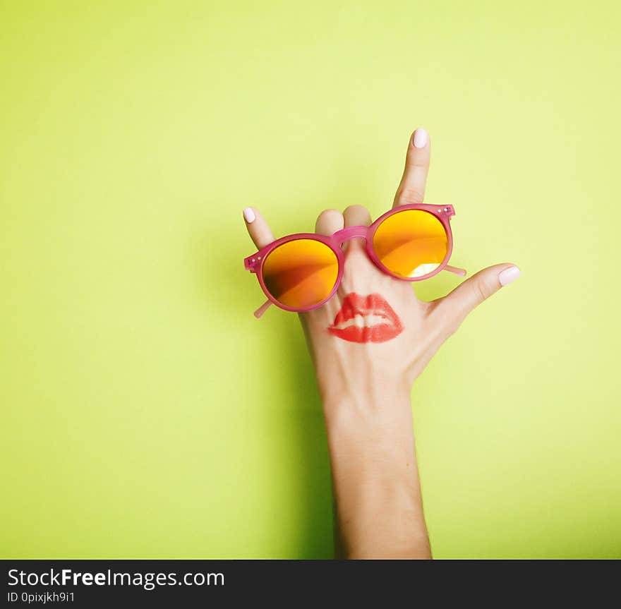 Woman Hand Holding Sunglasses On Bright Background, Cosmetic Summer Vacation Concept Close Up