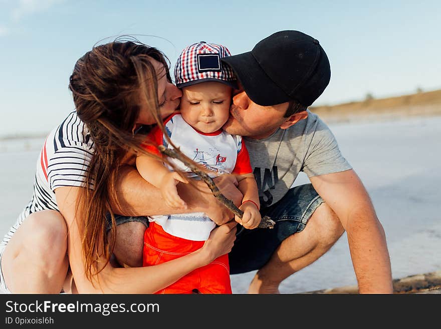 Funny portrait of a happy family on the beach