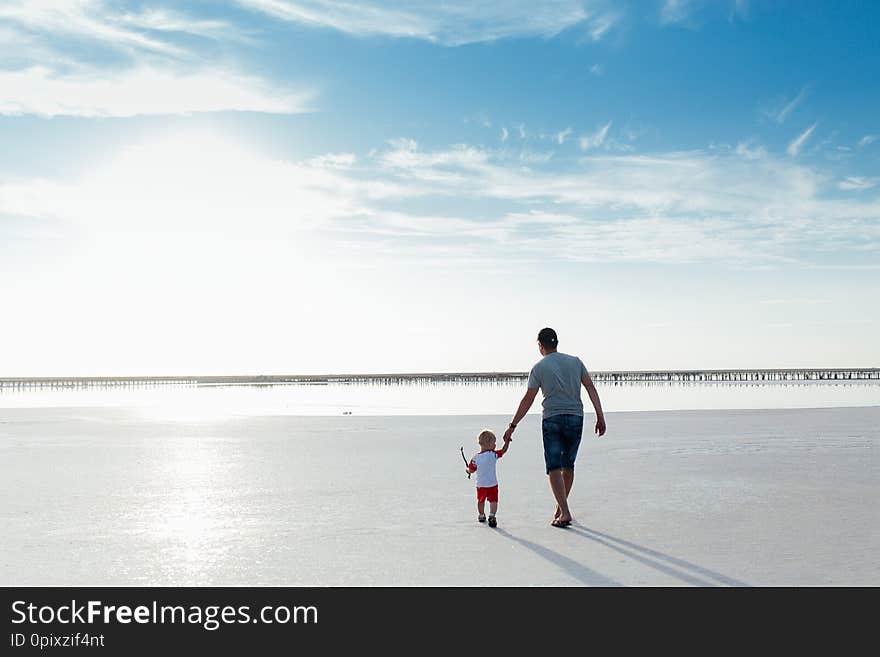 Portrait Of A Little Boy With His Father On The Beach