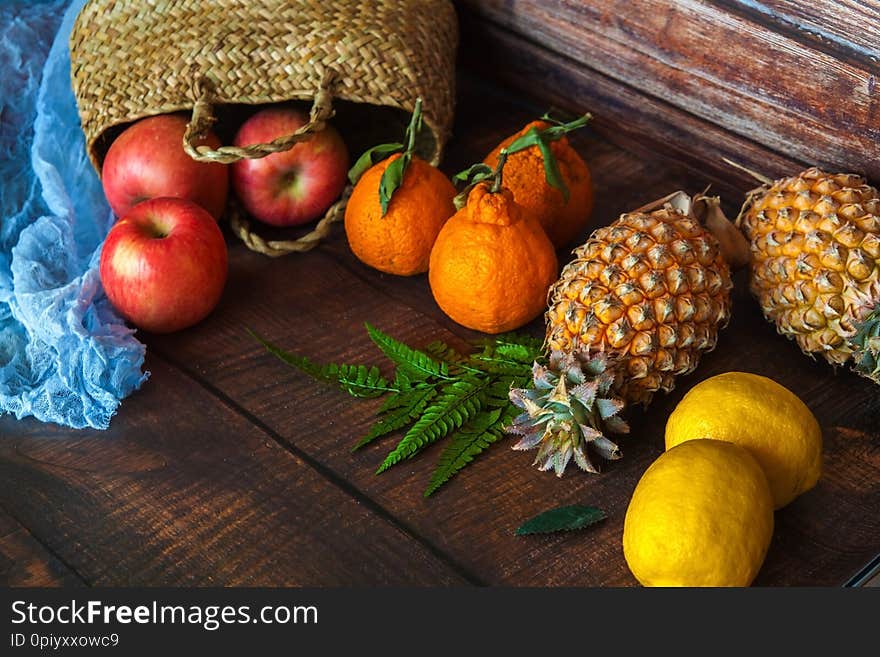 Background from many different exotic fruits. Healthy foods, pineapple, mango, apples, tangerines.