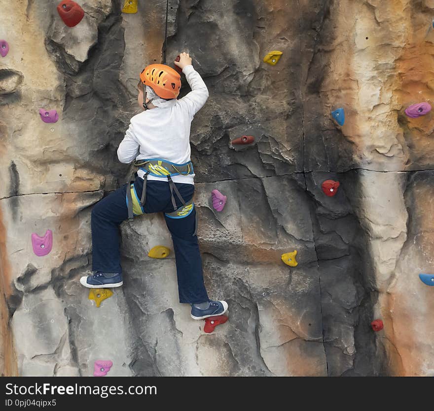 Boy on the climbing wall indoor.