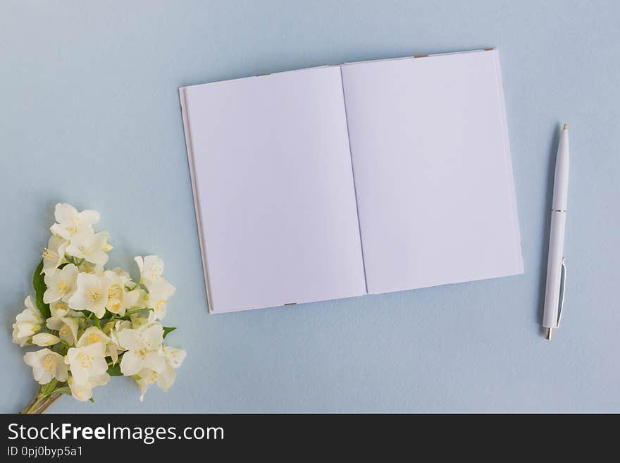 Mockup notebook with white jasmine flowers