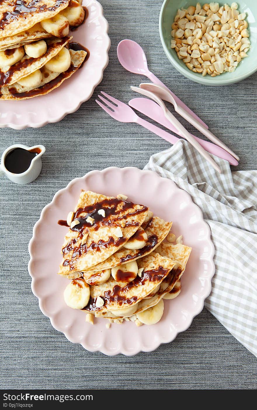 Delicious pancakes with fresh banana and chocolate sauce