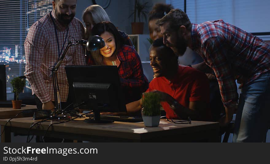 Successful man celebrating with coworkers