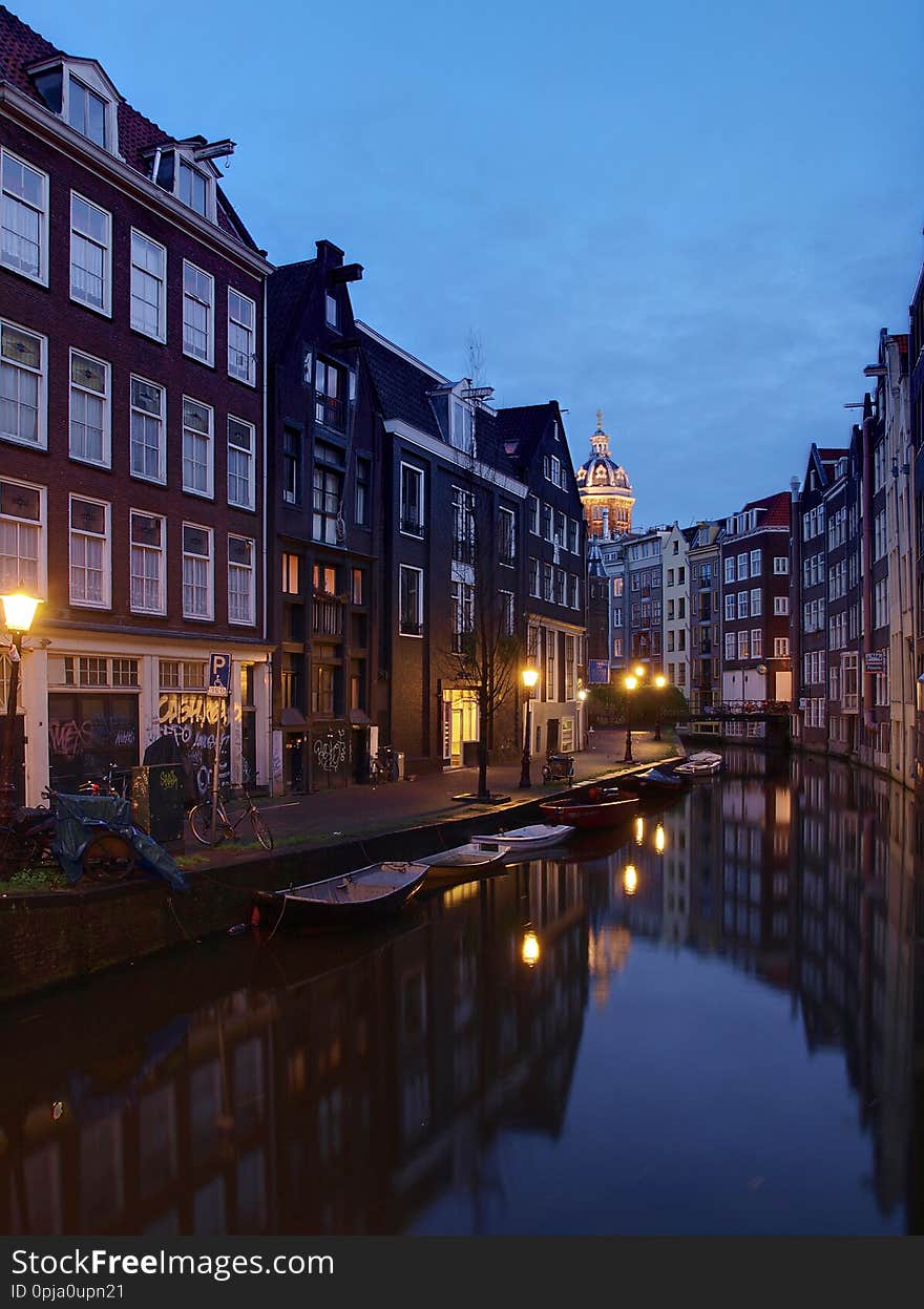 Amsterdam canal Amstel with typical dutch houses and houseboat from the boat in the evening, Holland, Netherland/s