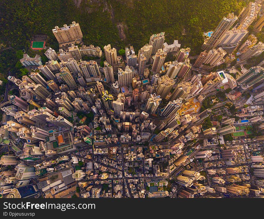 Aerial view of Hong Kong Downtown, China. Financial district and business centers in smart city in Asia. Top view of skyscraper and high-rise buildings at sunset. Top view