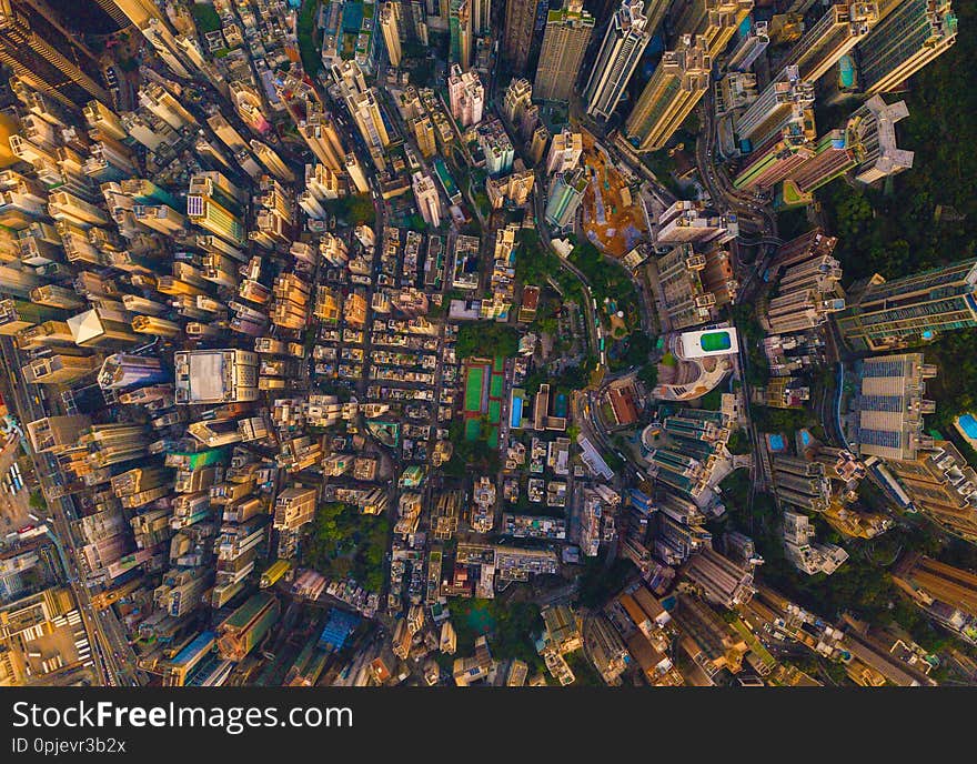 Aerial view of Hong Kong Downtown, China. Financial district and business centers in smart city in Asia. Top view of skyscraper and high-rise buildings at sunset. Top view