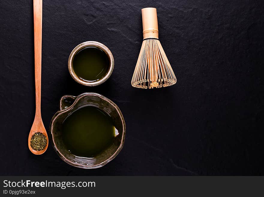 Top view of green tea matcha in a bowl on wooden surface