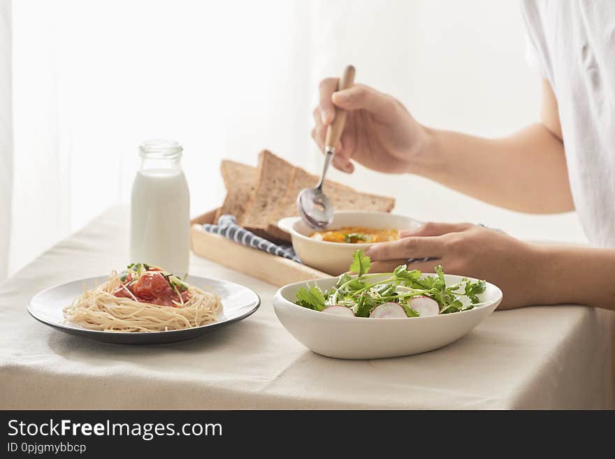 Cropped shot of male having breakfast at table in kitchen at home.