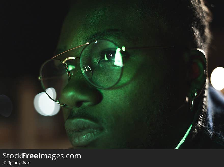 Retro neon portrait of an African American. Close-up black man with modern glasses