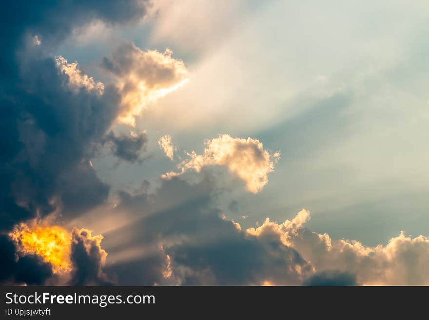 Abstract background, dark cumulonimbus and stormy clouds, dramatic sky, with sunlight breaking through clouds, rim light. Abstract background, dark cumulonimbus and stormy clouds, dramatic sky, with sunlight breaking through clouds, rim light