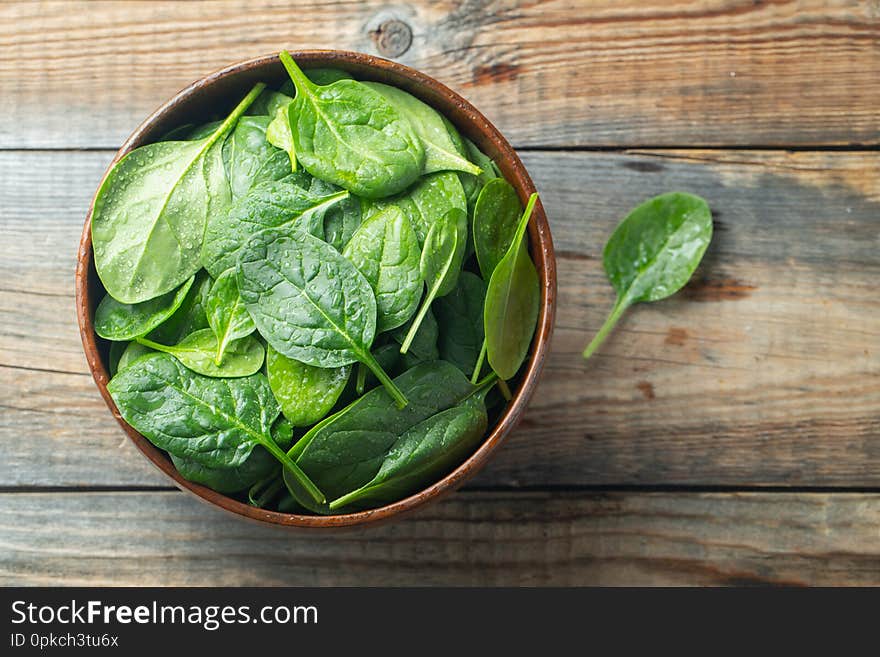 Fresh Spinach Leaves In Bowl On Wooden Table