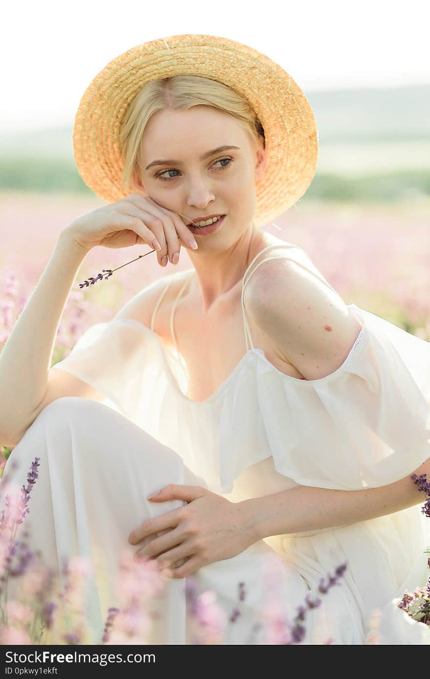 Wonderful portrait of girl in light dress in lavender field on sunset