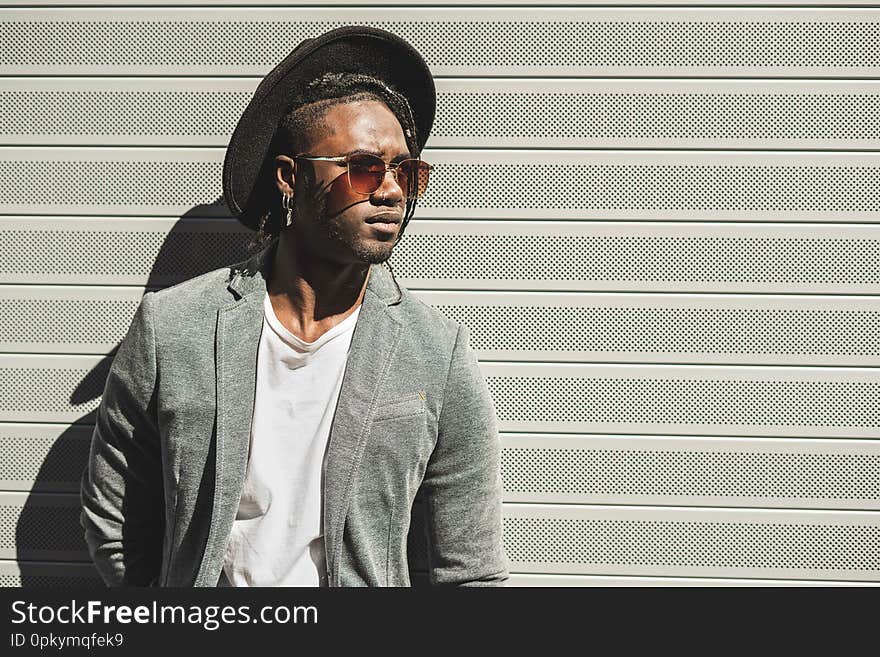 Portrait Young African American man dressed in style on the city street. Portrait Young African American man dressed in style on the city street