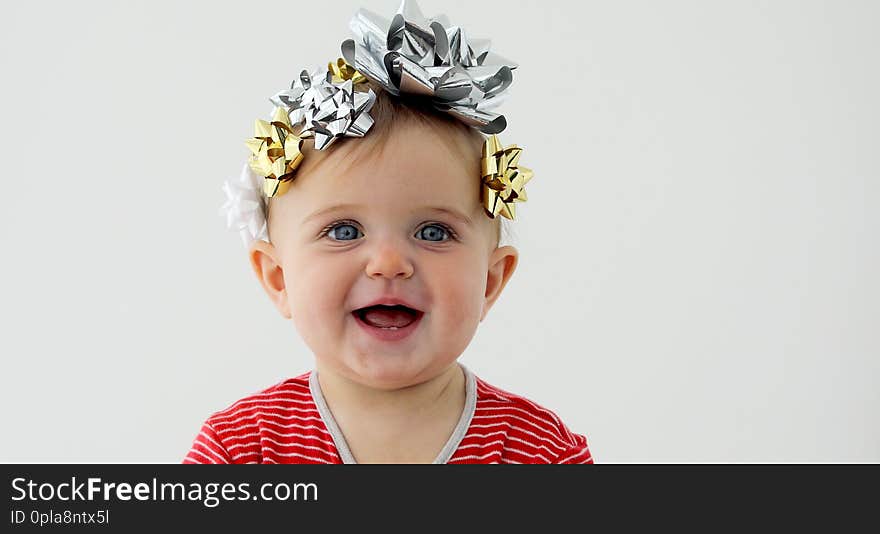 Baby decorated with a bow as a gift on a white background