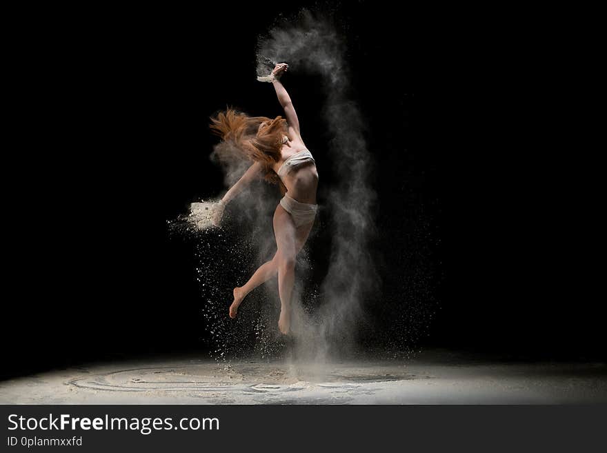 Slim blonde in bandage jumping in dust cloud shot