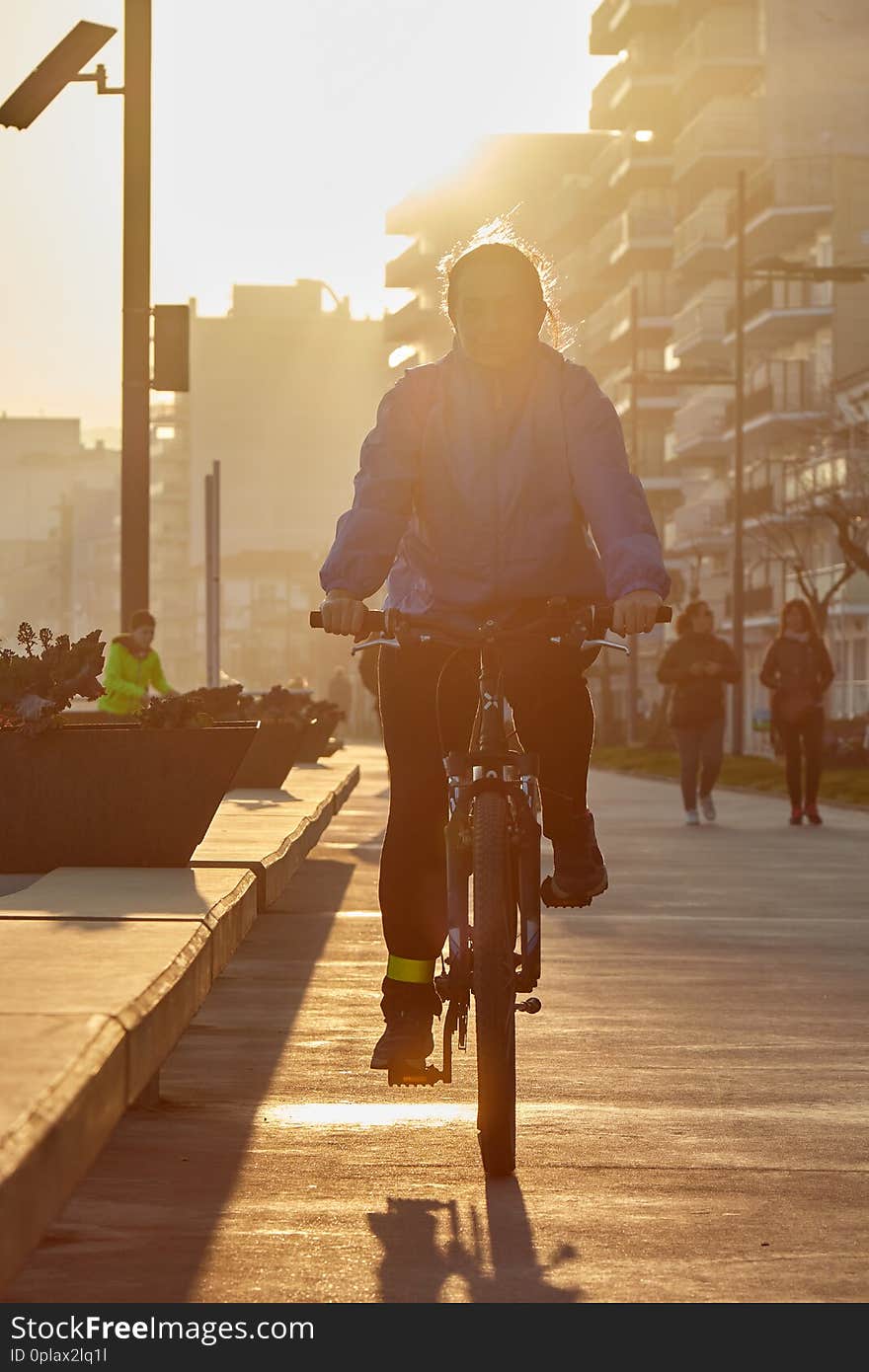 Girl biking in nice sunny back light