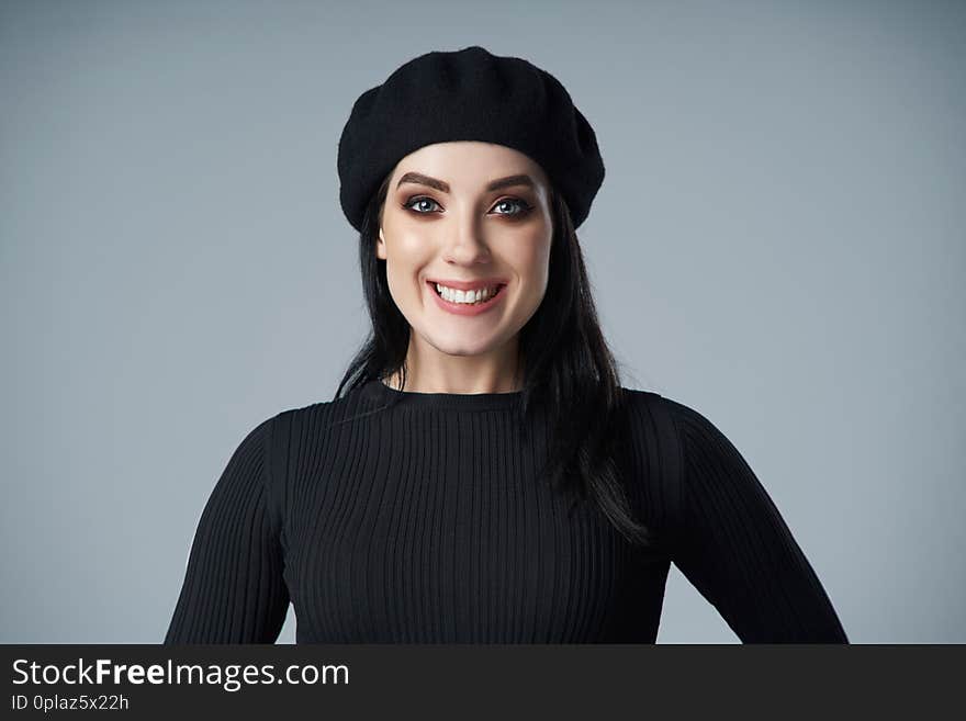 Portrait of smiling brunette girl in beret