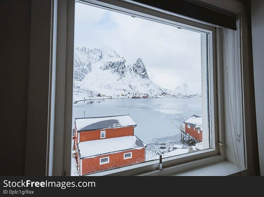 Incredibly beautiful view from the window of the house, an incredibly beautiful landscape of mountains, seas and boats in the winter in Norway on the Lofoten Islands