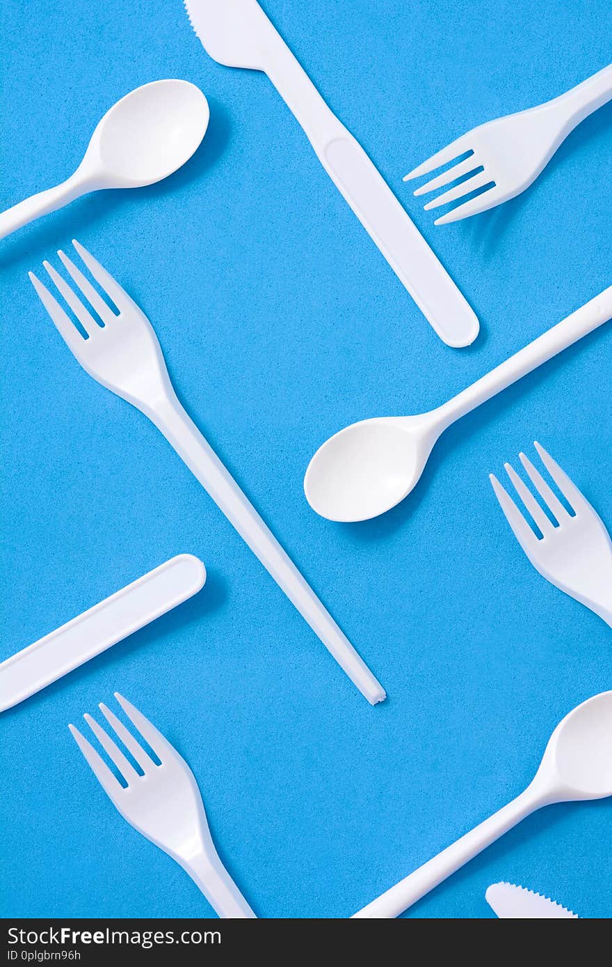 Disposable plastic tableware pattern on blue background