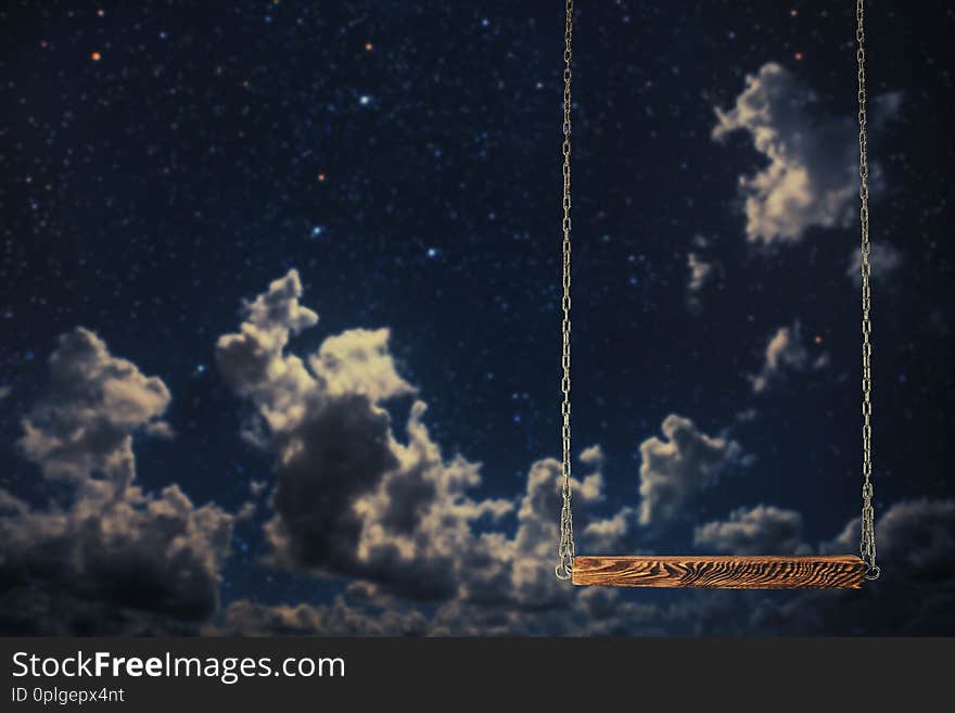 A swing on a night sky background