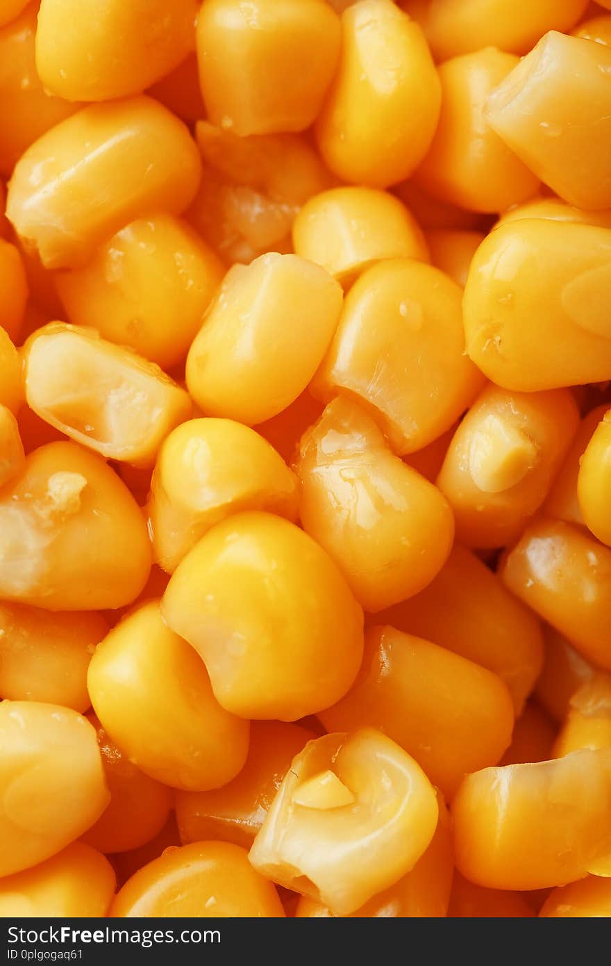 Golden canned corn, as distributed on a plane background and texture of popcorn. Before watching a movie top view. Close-up