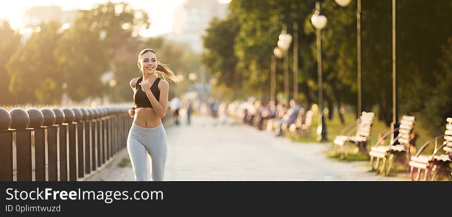 Millennial fitness woman jogging outdoors in park. Sport active lifestyle concept, panorama with empty space