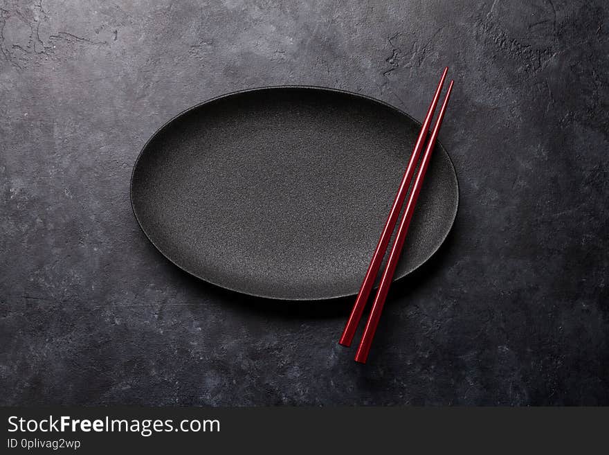 Empty plate and chopsticks