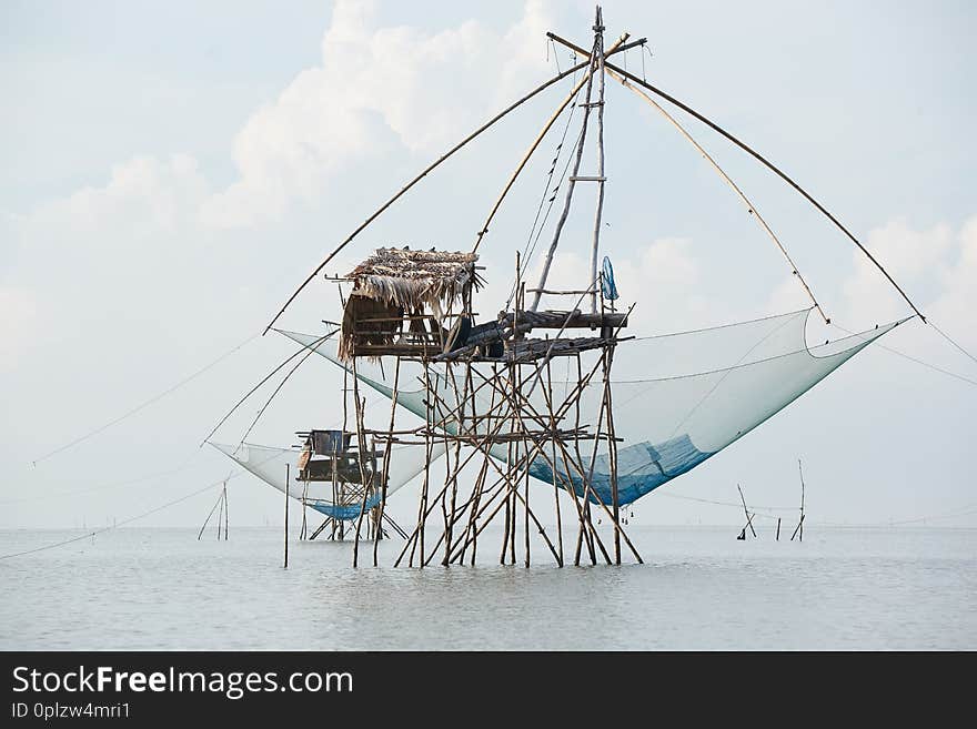 Close-up view of giant square net fishing in the sea in sunny day. Close-up view of giant square net fishing in the sea in sunny day