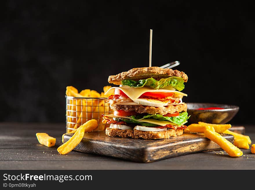 Tall club sandwich and french fries