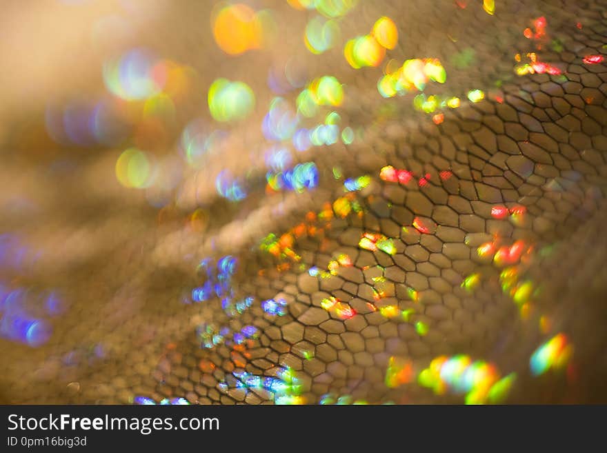 Golden glittering texture. Defocused bokeh light. Lens flare effect. Golden glittering texture. Defocused bokeh light. Lens flare effect.