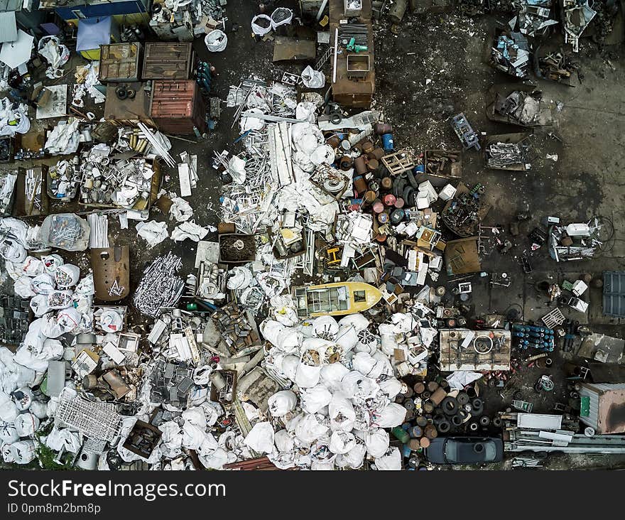 Scrap metal junkyard area aerial view. Reception and storage metal waste before recyclyng.Dark toned