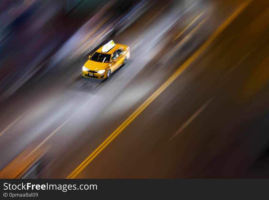 Overhead view of New York City taxi speeding down the road with blurred background. Overhead view of New York City taxi speeding down the road with blurred background