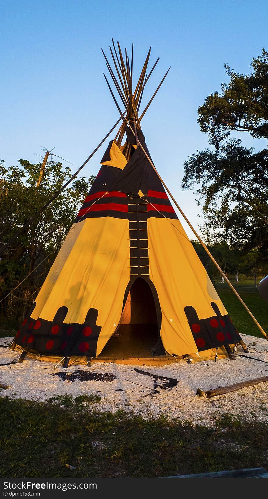 Tee Pee Style Tent with Canvas Side at a Public Park. Indian Style Teepee Tent with Canvas Material on a Wooden Platform