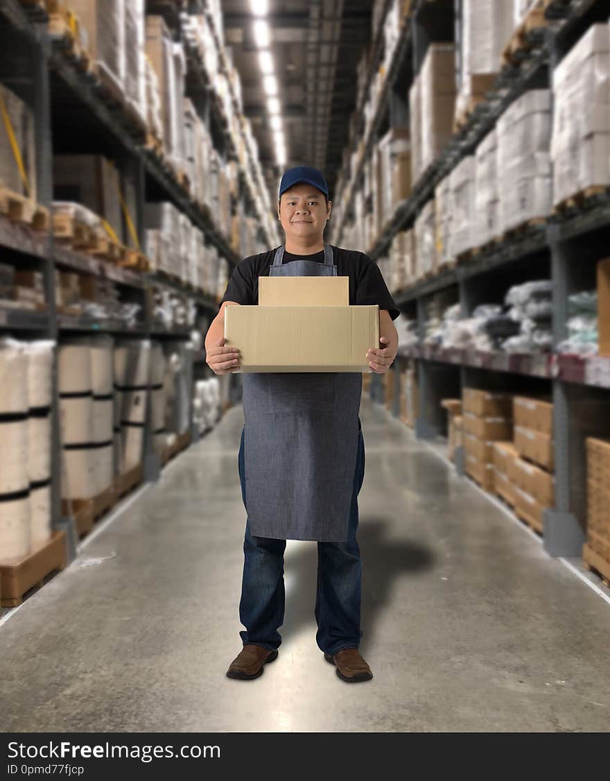 Worker holding parcel boxes with Blurred the background of the warehouse