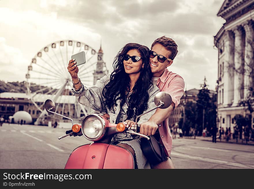 Beautiful memories. Positive nice couple standing together while taking a photo of themselves. Beautiful memories. Positive nice couple standing together while taking a photo of themselves