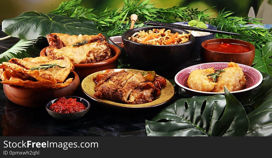 Assorted Chinese food set. Chinese noodles, fried rice, peking duck, dim sum, spring rolls. Famous Chinese cuisine dishes on table